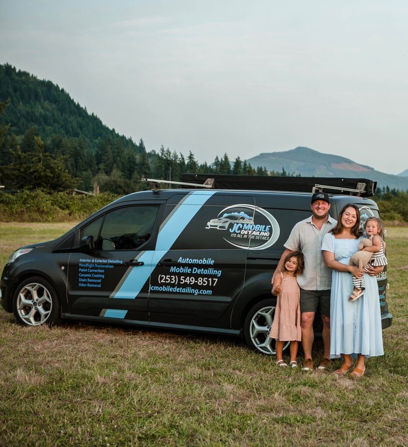 Jordan, owner of JC Mobile Detailing, with family beside a branded van